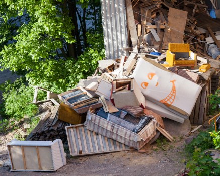 Man with van removing waste from a terraced property